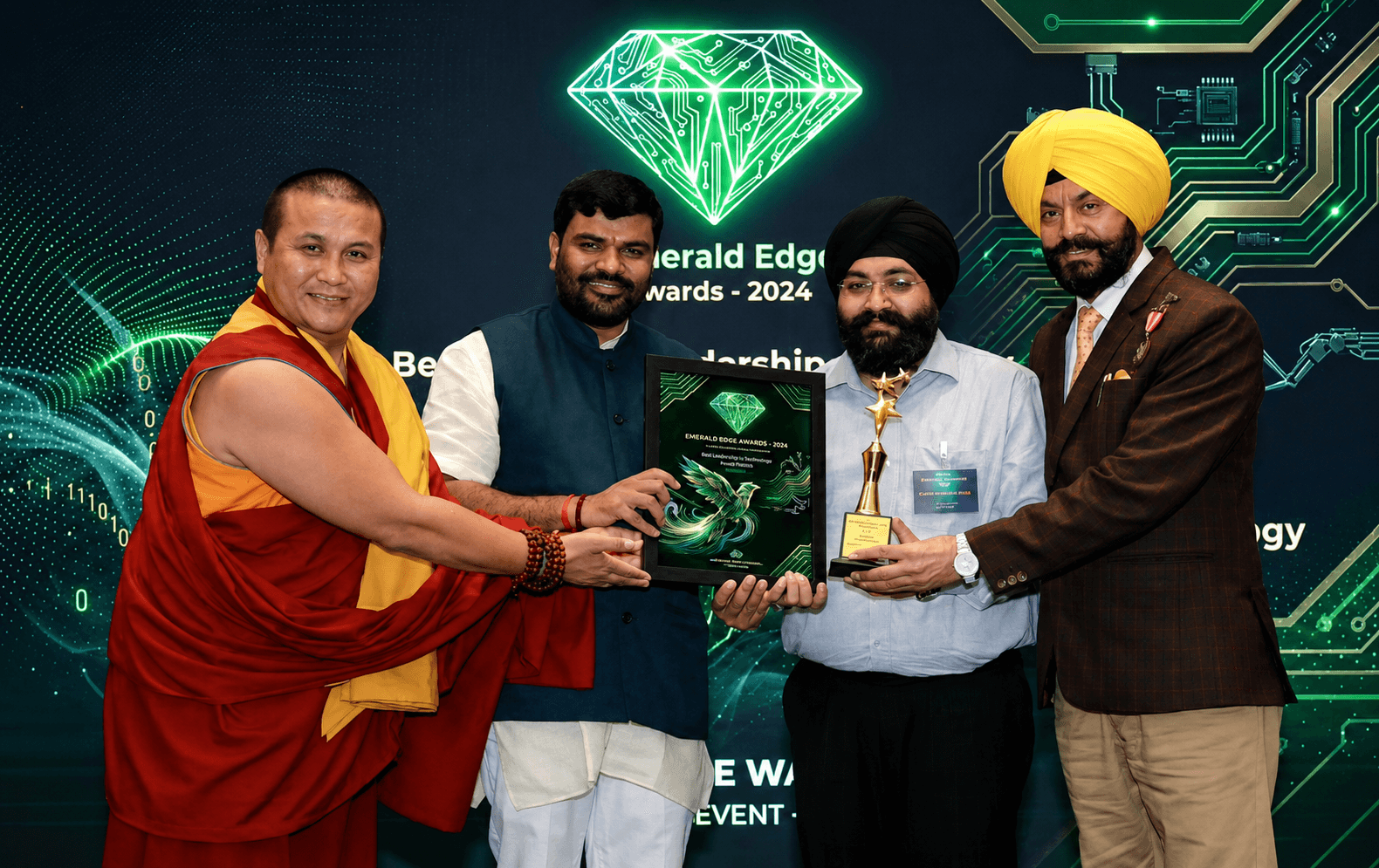 Award handover photo with recipients and stage branding